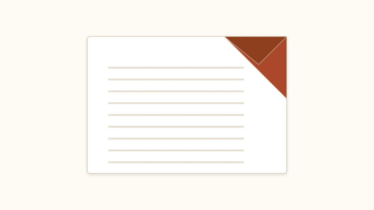 Orange origami bookmark fitted over the corner of an open book