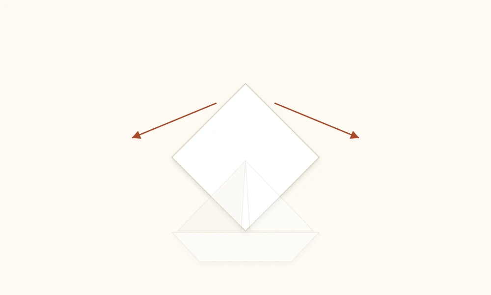 Paper diamond with its top points being pulled apart to form the boat